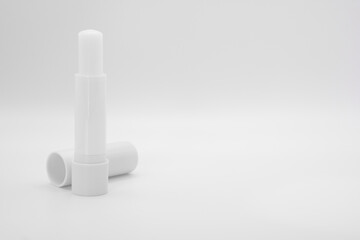 opened stick of lip balm on white background
