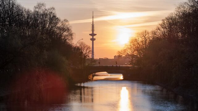 Hamburg, Germany: view of a canel and a bridge at Alster Lake in the sunset, 4k, time lapse