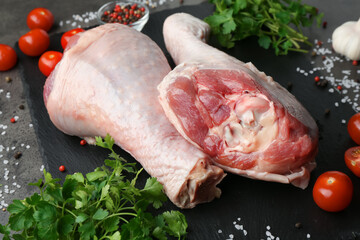 Raw turkey drumsticks and ingredients on grey table, closeup