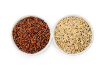 Different sorts of raw brown rice isolated on white, top view