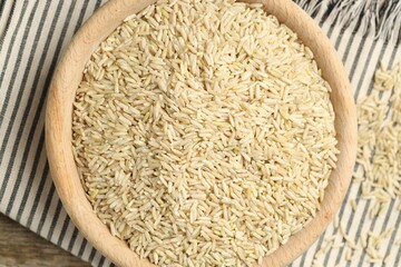 Brown rice in bowl on table, top view