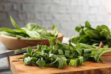 Cut fresh sorrel leaves and knife on table, closeup