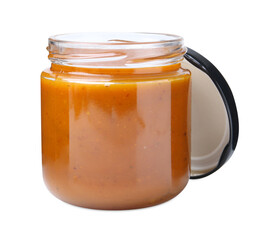 Tasty curry sauce in glass jar isolated on white