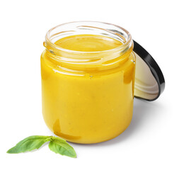 Tasty curry sauce in glass jar and basil isolated on white
