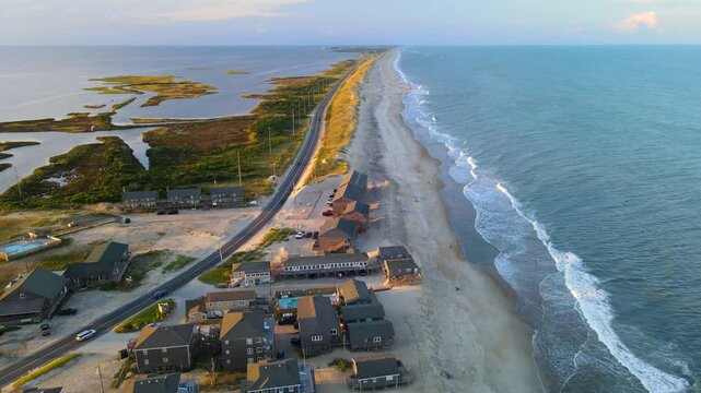 Cape Hatteras at Sunset. The Atlantic Ocean shore, hotels, villas and the road to Cape Hatteras.

