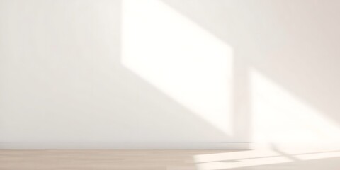 Obraz premium Soft natural light enhances a minimalist empty wall, its smooth, neutral surface showing subtle texture. Bright vibrant colors contribute to a warm, modern aesthetic, perfect for mockups, product 