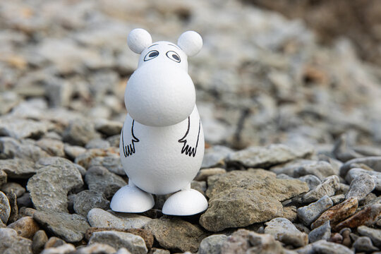 Tallinn, Estonia. September 1st, 2024. Wooden moomin figure placed on a rock by the sea, symbolizing nordic literature, whimsical characters, and the timeless charm of Tove Jansson creations.
