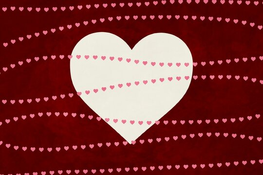 Large heart with pink mini hearts on red textured background