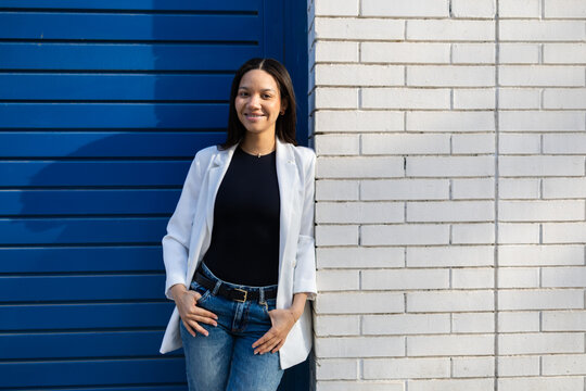 Confident ethnic woman in casual business attire outdoors