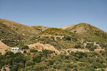 Fototapeta premium A single building on the slopes of the mountains located in western Crete
