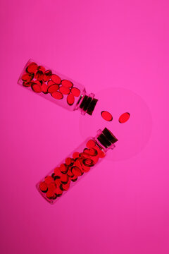 Colorful Omega-3 and Vitamin D capsules in glass bottles