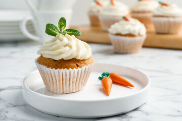 Delicious carrot cupcake with mint on white marble table, closeup