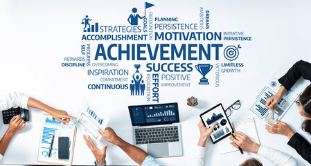 Diverse team members engage in a collaborative business meeting focusing on achievement and motivation. They analyze data and exchange insights to drive success and improvement. Amity