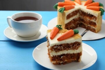 Delicious homemade carrot cake served on light blue wooden table, closeup
