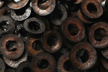 Marinated black olive rings as background, top view