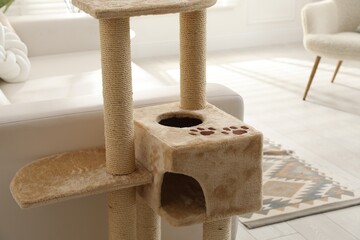 Big comfortable cat tree with scratching poles indoors, closeup