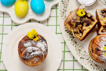 Easter cruffins with chocolate filling on Easter background and painted eggs.