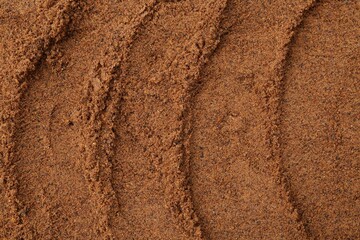 Superfood. Nutmeg powder as background, top view