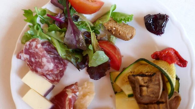 Delicious antipasti plate with meat, cheese, salad 