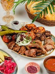 Azerbaijani kebab assortment in big plate. Lamb chops kebab, lula kebab, chicken kebab, vegetables kebab