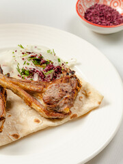Lamb chops kebab on lavash close up