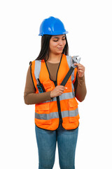 vertical Confident Latina construction worker holding an adjustable wrench and a walkie-talkie
