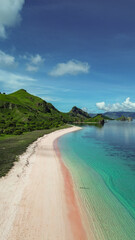 blue sky during the green season at Pink Beach, Labuan Bajo from above taken by Drone Aerial 