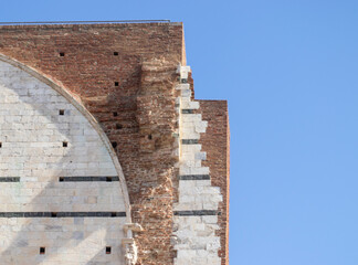 historical building original coating and brick texture underneath together. restoration and architecture. Italy