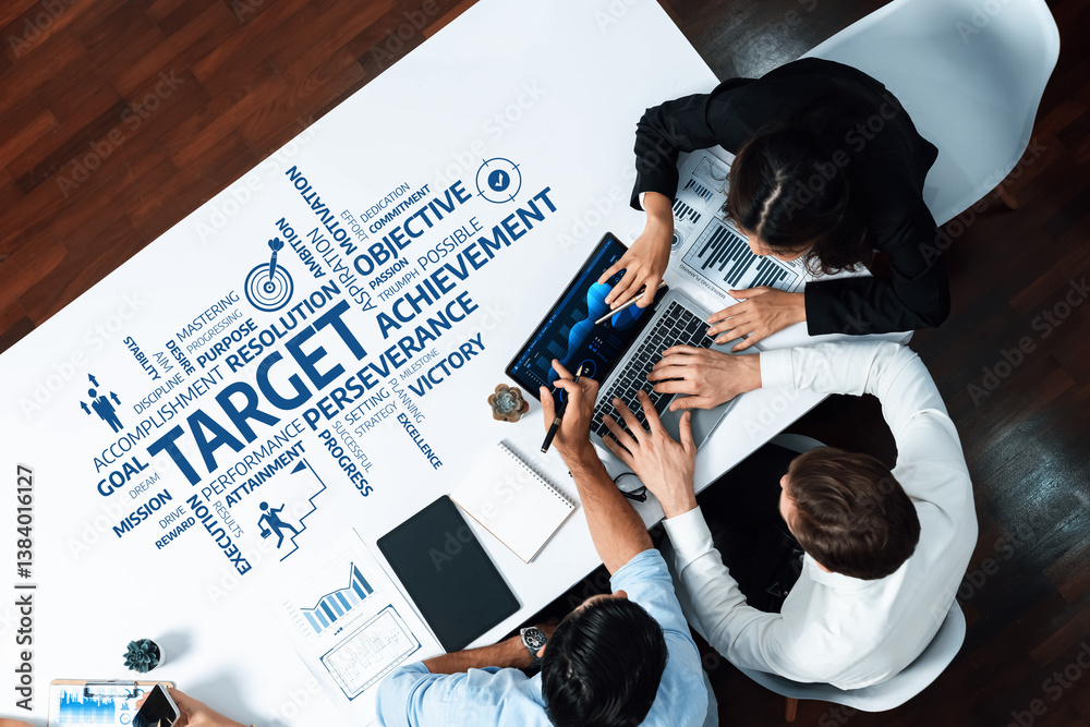 Poster A high-angle view of a diverse business team engaged in a dynamic meeting, focusing on data analysis and strategic planning to achieve targets and foster collaboration. Amity