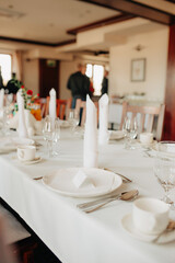 Close-up of birthday party table setting – white tablecloth, elegant decor for a festive celebration