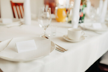 Close-up of birthday party table setting – white tablecloth, elegant decor for a festive celebration