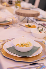 Close-up of birthday party table setting – white tablecloth, elegant decor for a festive celebration