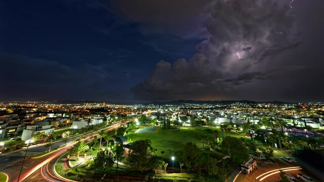Horizontal landscaped video of Puebla cityscape with purple lightnings during nighttime
