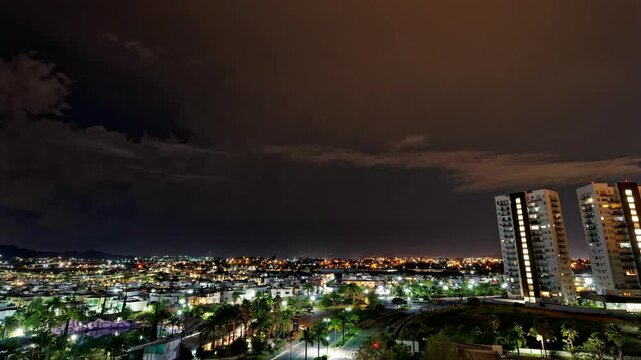 Horizontal landscaped video of Puebla cityscape with purple lightnings during nighttime