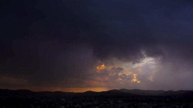 Horizontal landscaped video of Puebla cityscape with purple lightnings during nighttime