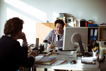 Young men having a meeting in a journalism office