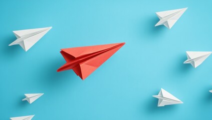 Fototapeta premium Red paper airplane standing out among many white ones