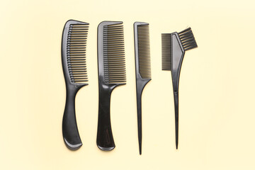 Hairdresser's brushes on beige background