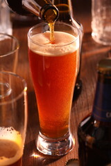 glass of beer and bottle of beer on wooden table
