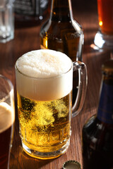 glass of beer and bottle of beer on wooden table