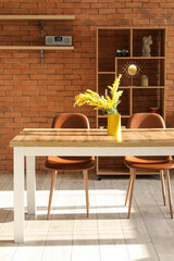 Interior of comfortable living room with table, chairs and shelving unit