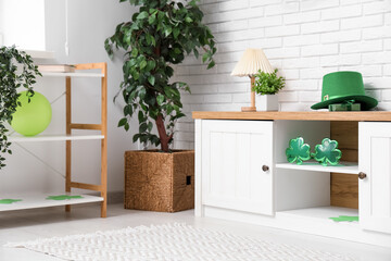 Interior of light living room with white furniture and decorations for St. Patrick's Day celebration
