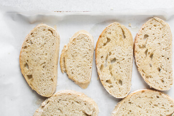 Overhead view of sliced homemade artisan bread, top view of baked sourdough artisan bread slices