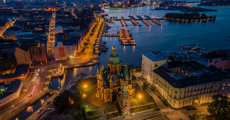 Drone photo of Uspenski Cathedral at night, Helsinki, Finland. City lights and architecture viewed from above