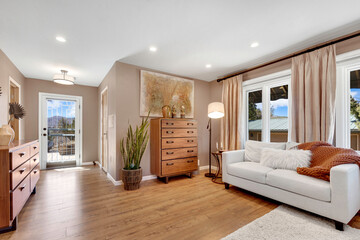 A cozy bedroom featuring a comfortable bed, a desk, a chair, and some lamps