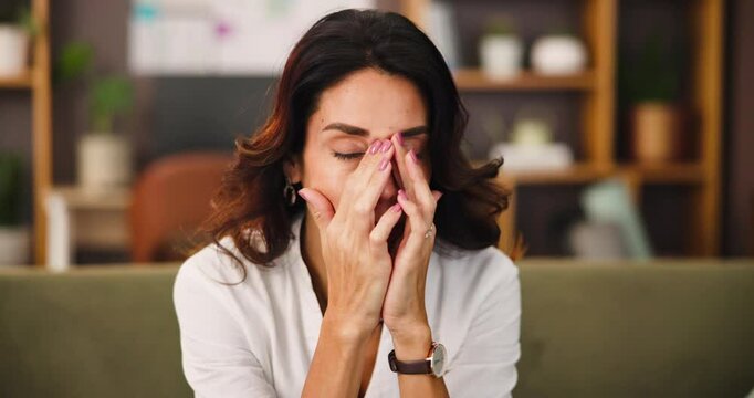 Headache, exhaustion and woman on sofa in home with brain fog, fatigue or hangover recovery. Stress, mental health and female person with temple massage for pain, tired or burnout in apartment.