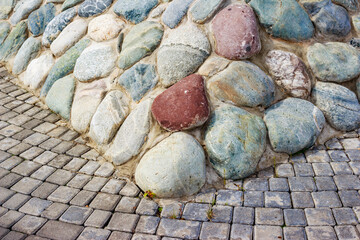 Laying natural stones at the base of a monument in a city square
