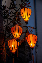 Obraz premium Colorful red chinese decorative lanterns shining in the evening with electric light. Red round lantern