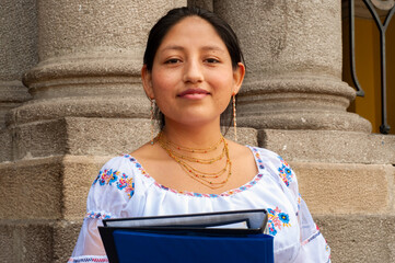 A Young Woman Dressed in Traditional Attire Holding Documents, Representing Heritage and Culture