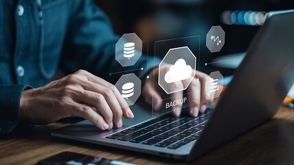Close-up view of hands typing on a laptop keyboard with overlaid digital icons representing cloud backup and data storage.